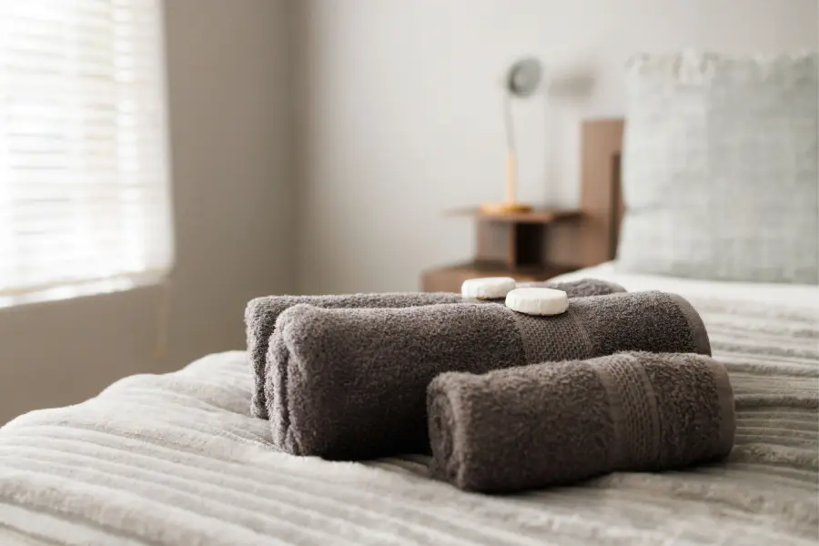 Fresh towels prepared on a bed at Goedehoop 2