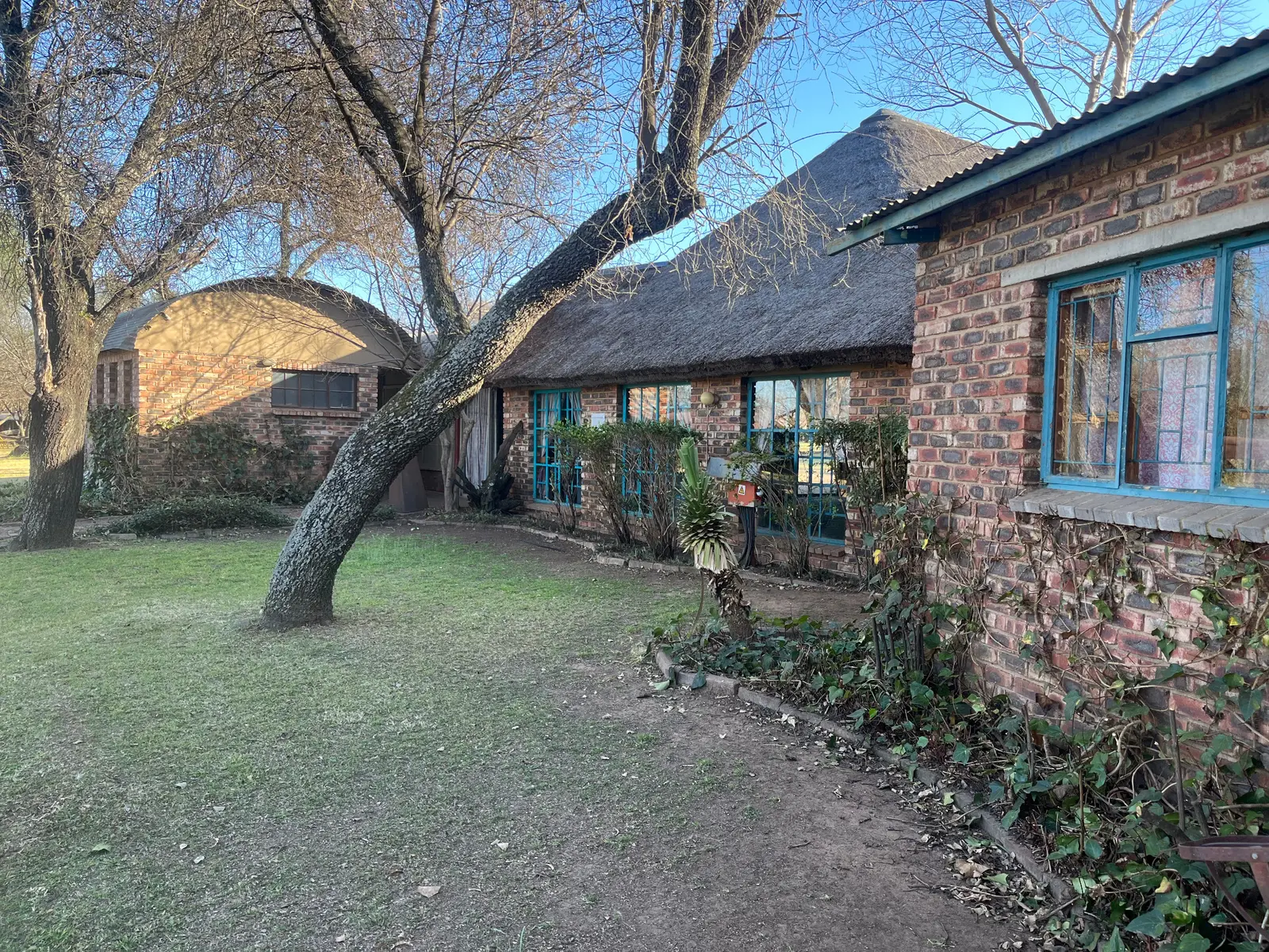 The lodge buildings and garden at Raaswater River Lodge